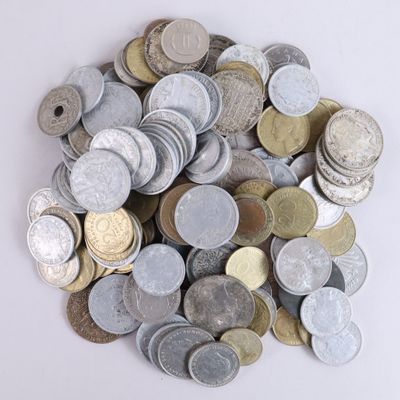 a pile of silver and gold coins on a white surface