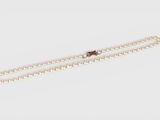 a white pearl necklace with a gold clasp on a white background