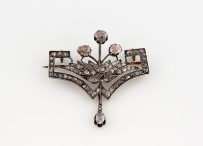 un gros plan d'une broche ornée d'un motif floral