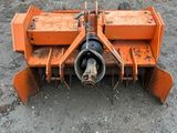 an orange tractor plow sitting in the dirt
