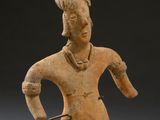 statue of a woman holding a pair of scissors in her right hand