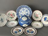 a lot of plates and bowls that are sitting on a table