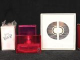 many different perfumes and boxes on a black surface