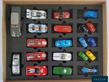 many toy cars in a box on a table