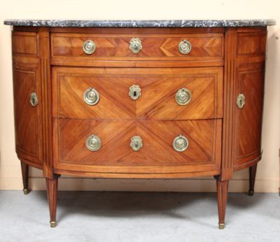 an image of a wooden dresser with marble top in a room