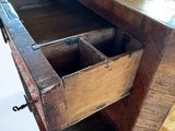 a wooden desk with two drawers on top of it