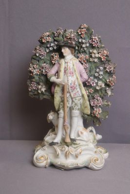 a figurine of a woman holding a parasol