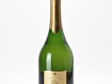 a close up of a bottle of champagne on a white surface