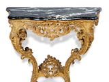an ornately carved console table with a marble top