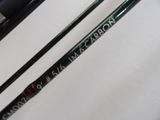 two different types of fishing rods on a white surface