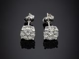 a pair of diamond earrings on a black background