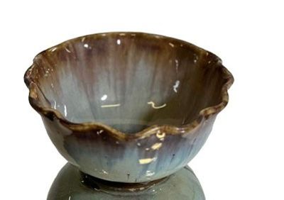 a blue and brown bowl sitting on top of a table