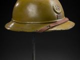 an old helmet on a stand with a black background