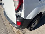 a white truck that has its door open and is parked on the side of the road