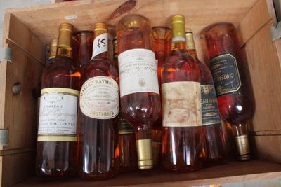 many bottles of wine sitting in a wooden box