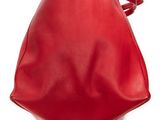 the large red bag is sitting on top of a white surface