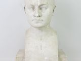 marble bust of a young boy with short hair on a white background