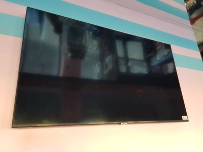 the flat screen tv is hanging on the wall in the room