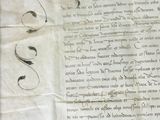 an old document with writing on it sitting on a table