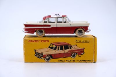 a red and white toy car sitting on top of a box