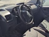 the interior of a car with the door open and the driver ' s seat down