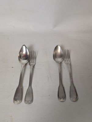 four spoons and two spoons sitting on a table
