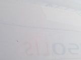 a plane that is flying in the sky with a sign on it