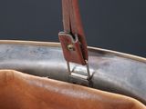 a close up of a brown leather bag with a handle