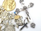 a lot of religious items that are laying out on the table