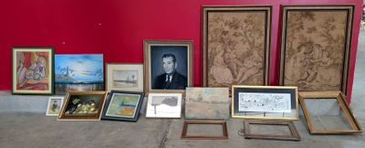 many framed pictures on the floor of this room