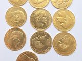 a close up of a bunch of gold coins on a white surface