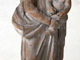 an old statue of a woman holding a child in her arms