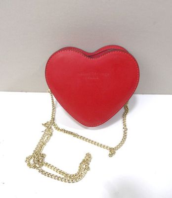 a red heart shaped purse with a gold chain