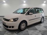 the white van is parked on a checkered floor in the garage