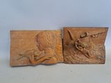 pair of carved wood plaques depicting a woman and a child