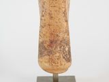 sculpture of a piece of wood on a stand on a white surface