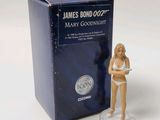 a figurine of a woman in a bikini standing next to a box