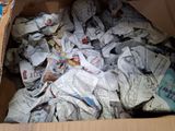 a cardboard box full of newspapers and other papers