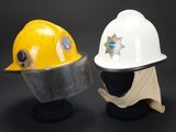 pair of yellow and white hard hats sitting on top of each other