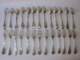 many forks and spoons laid out on the table