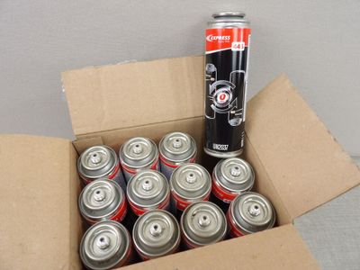 a box full of cans of soda sitting on the floor