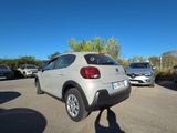 cars parked in a parking lot with a blue sky in the background