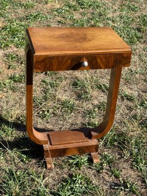 a small wooden table with a drawer in the middle of it