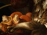 a painting of a bird that is laying on a basket