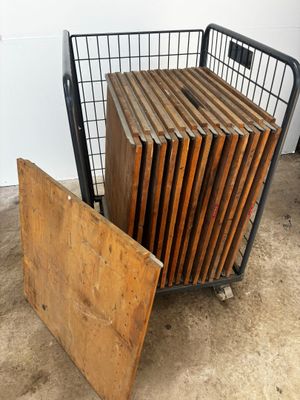 a lot of wooden boards in a metal cage