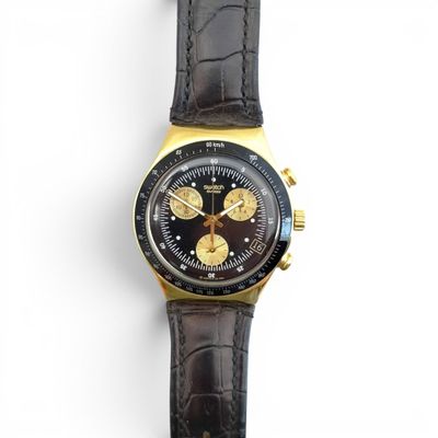 a close up of a watch on a white surface