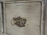 a close up of a dresser with drawers and a mirror