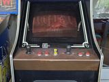 a game machine that is sitting in the corner of a room
