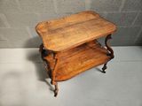 a small wooden table with two shelves on it