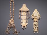 several pieces of jewelry are displayed on a gray surface